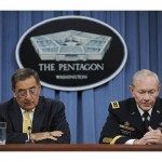 Panetta and Dempsey look down at their notes as they hold a news conference at the Pentagon in Washington